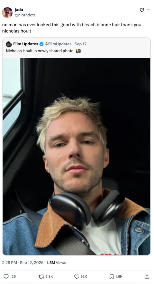 Nicholas Hoult taking a selfie wearing a denim jacket and headphones around his neck