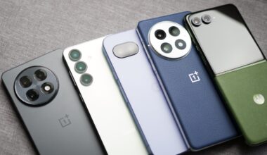 The OnePlus 13R, Galaxy S25, Pixel 9a, OnePlus 13, and Motorola Razr Plus (2024) are laying next to each other.