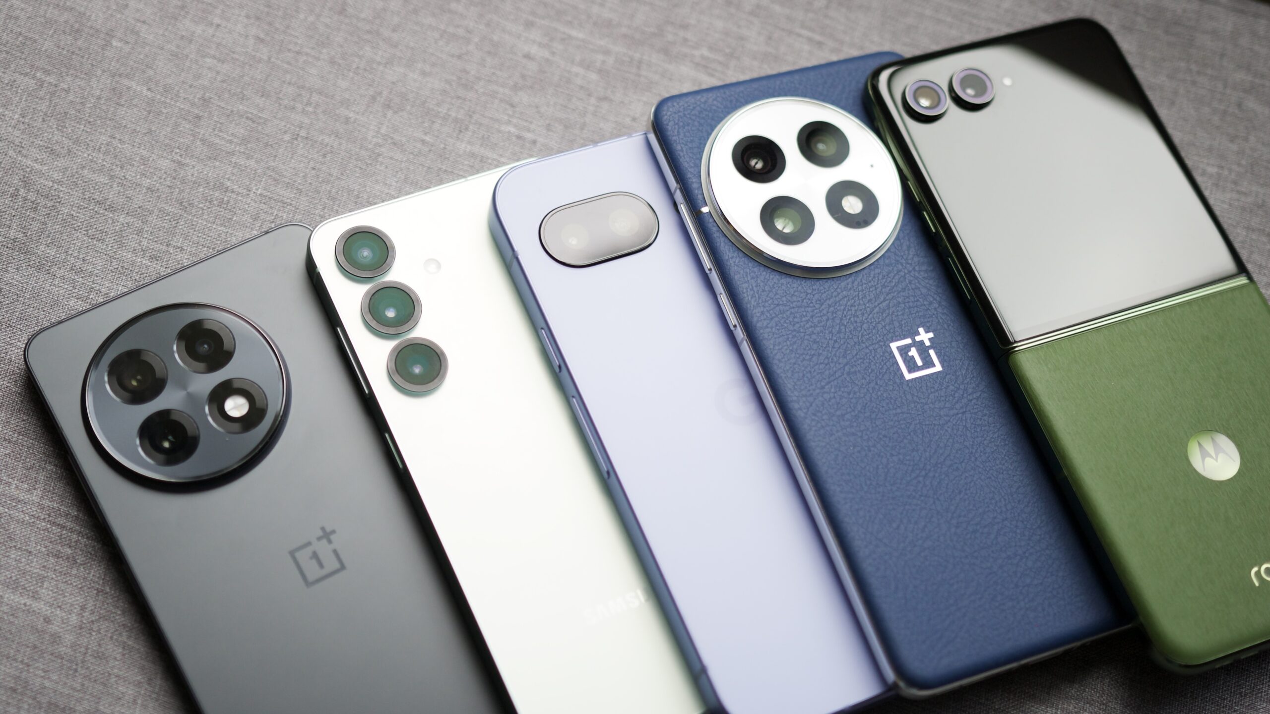 favorite android phones prime day 2025 1 The OnePlus 13R, Galaxy S25, Pixel 9a, OnePlus 13, and Motorola Razr Plus (2024) are laying next to each other.