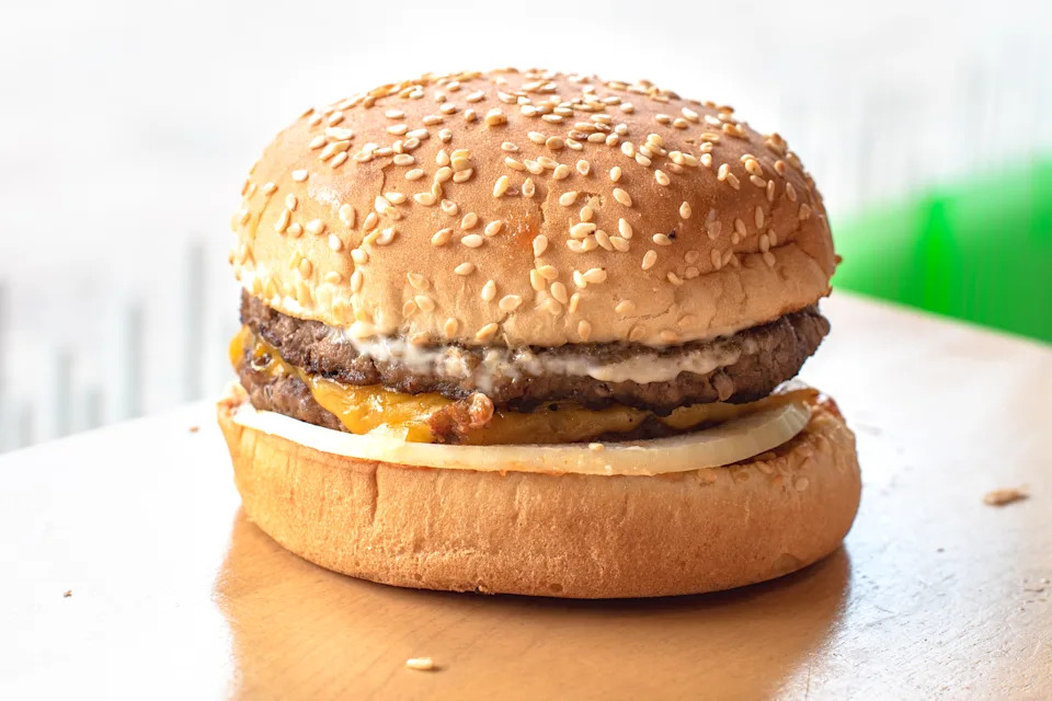TORONTO, ONTARIO, CANADA - 2018/12/15: Real serving of an A&W hamburger over a wood table surface. The image is back lit. A&W Restaurants, Inc. is a chain of fast-food restaurants distinguished by its draft root beer, and burgers. (Photo by Roberto Machado Noa/LightRocket via Getty Images)