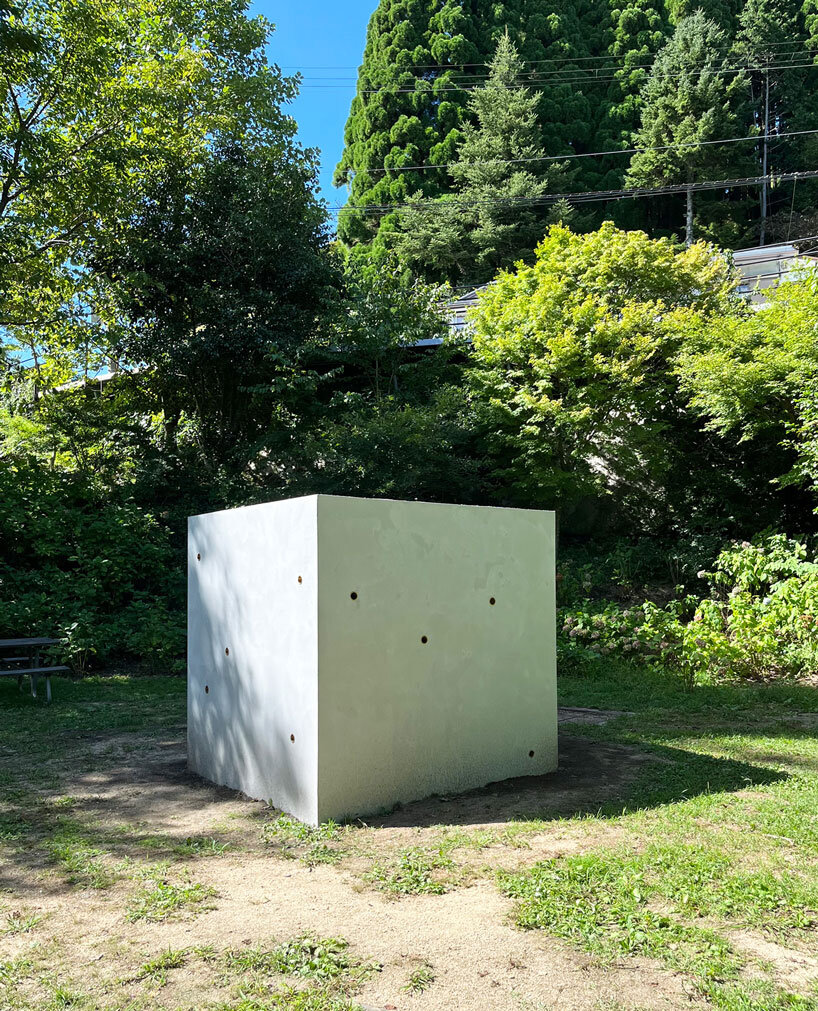 twin concrete cube sculptures link rokko and berlin through tiny video transmission holes