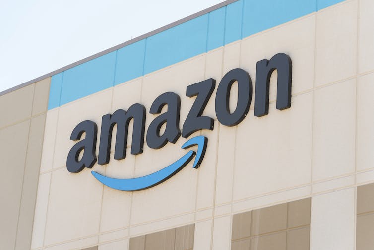 The Amazon logo is seen on the exterior wall of a building