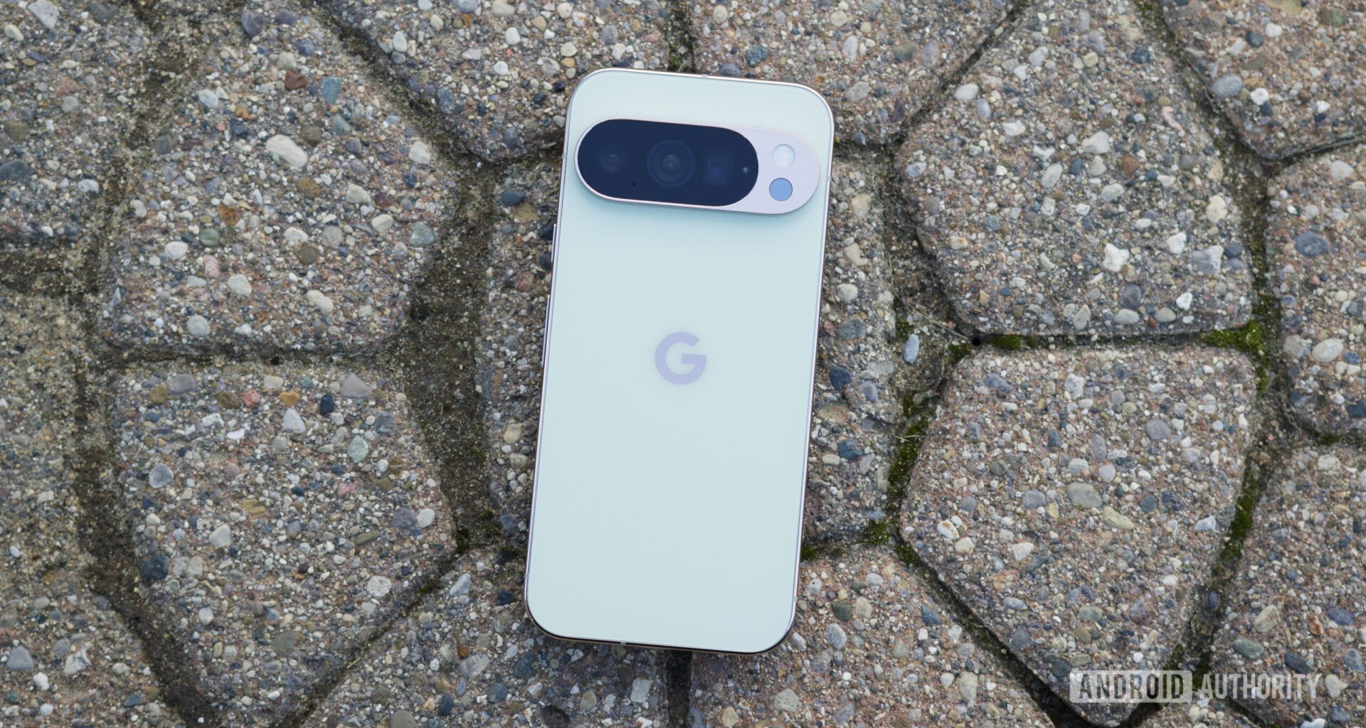 The Google Pixel 10 Pro laying face-down on the pavement.