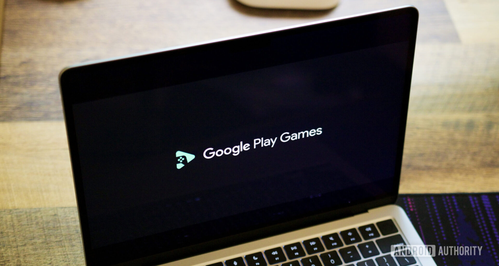 Google Play Games logo on a laptop screen.