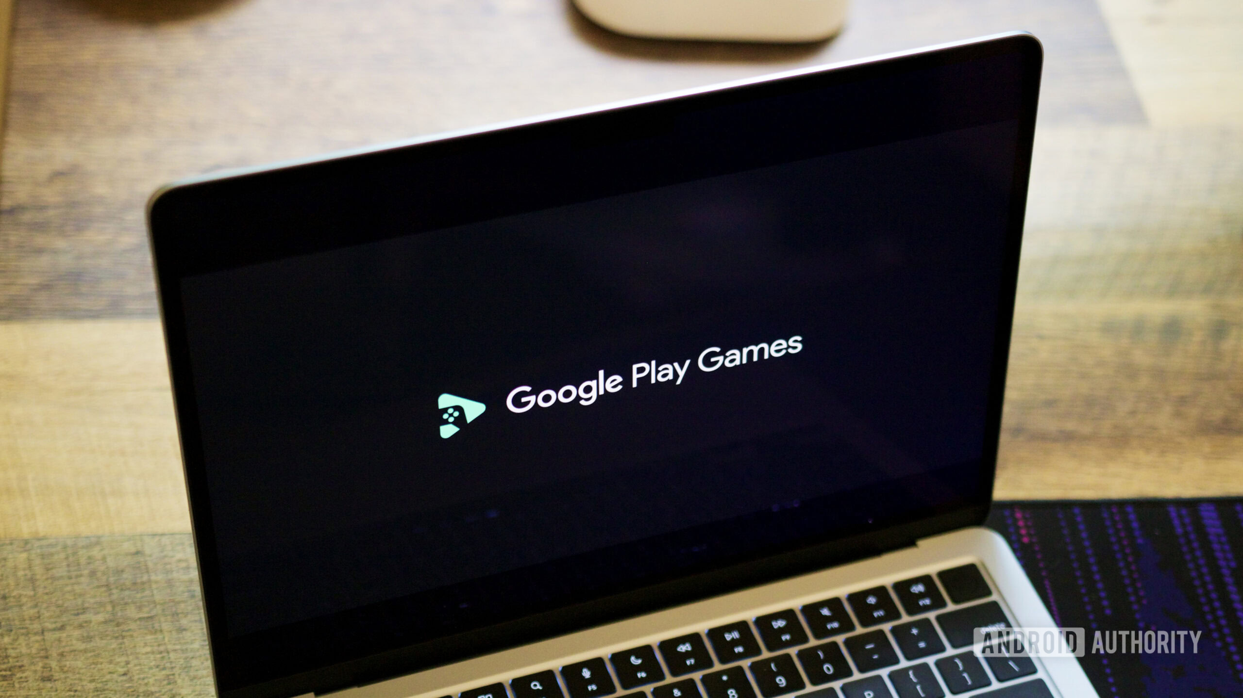 Google Play Games logo on a laptop screen.