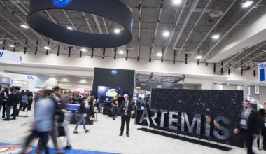 Attendees are seen by the NASA exhibit at the 70th International Astronautical Congress, Friday, Oct. 25, 2019, at the Walter E. Washington Convention Center in Washington.