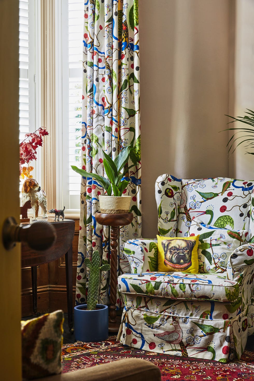 Josef Frank fabric in Emily Sutton’s sitting room armchair and curtains upholstered in josef frank gröna fåglar linen with a handmade bulldog cushion
