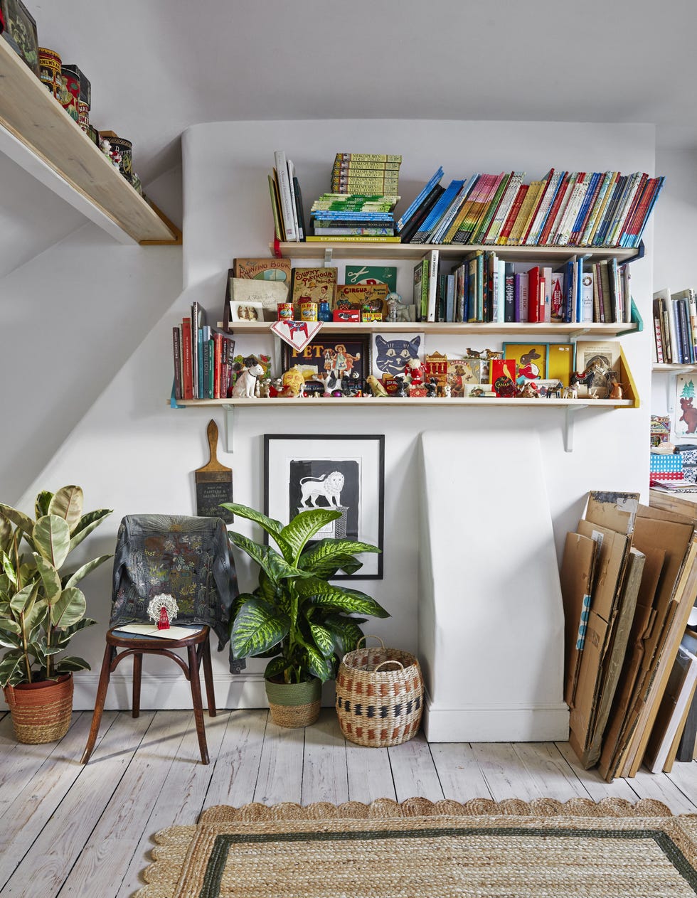 Emily Sutton’s attic studio with vintage collections attic studio with white walls, artwork in progress, and emily sutton’s shelves of vintage collections