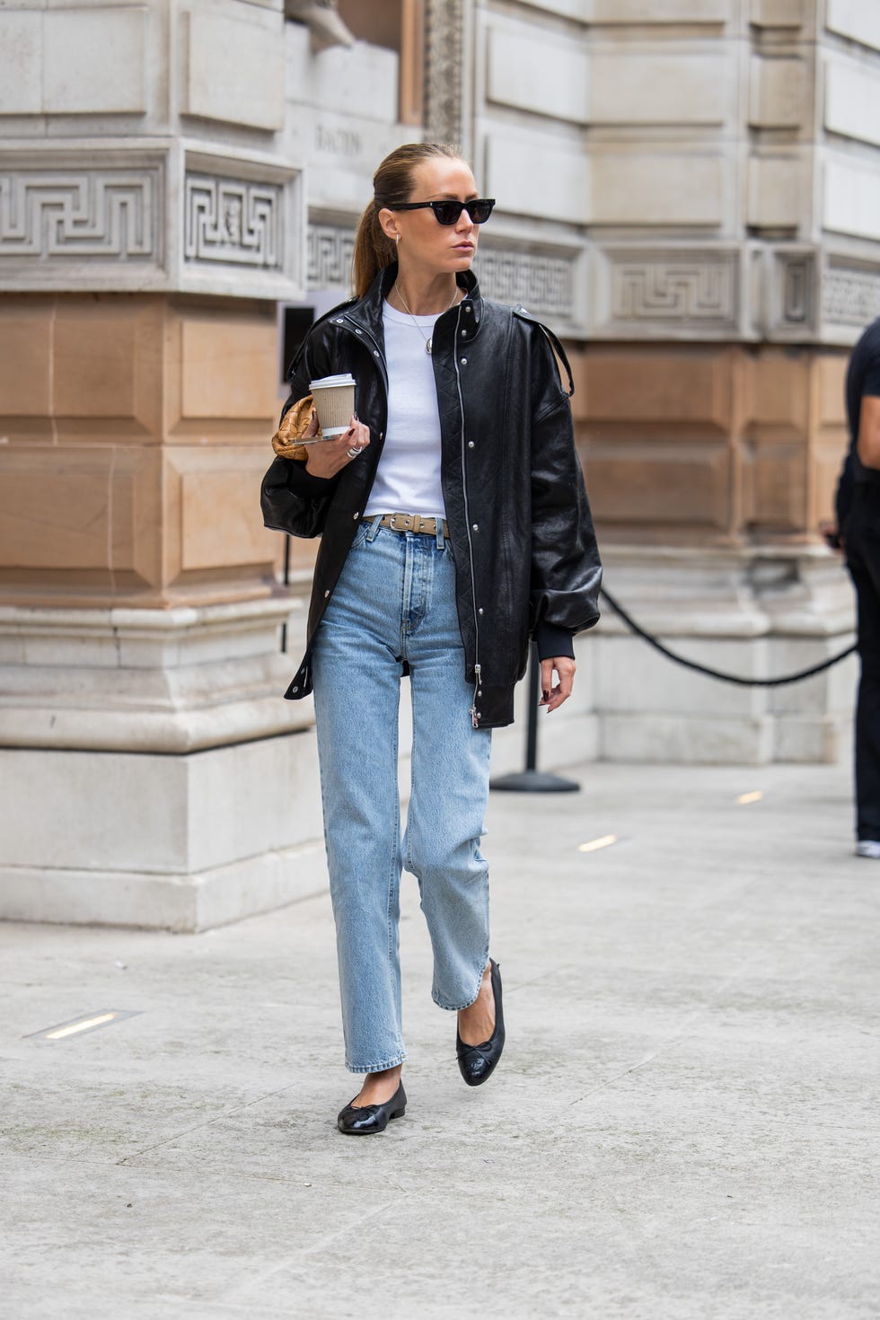 london, england september 15: a guest wears brown bag, leather jacket, denim outside 16arlington during london fashion week september 2024 on september 15, 2024 in london, england. (photo by christian vierig/getty images)
