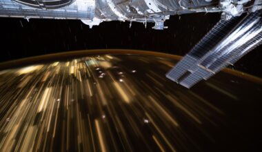 The warm city lights of Southeast Asia streak below the silvery U.S. segment of the International Space Station in this 30-second exposure from the orbital outpost as it soared 259 miles above China at approximately 10:39 a.m. local time. Near the top center, is the partially obscured SpaceX Dragon spacecraft that docked to the Harmony module's forward port carrying NASA's Crew-11 mission.