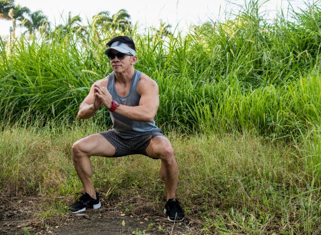 fit man doing jump squats