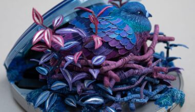 a sculpture by Stéphanie Kilgast of a colorful bird nesting inside of a portable CD player