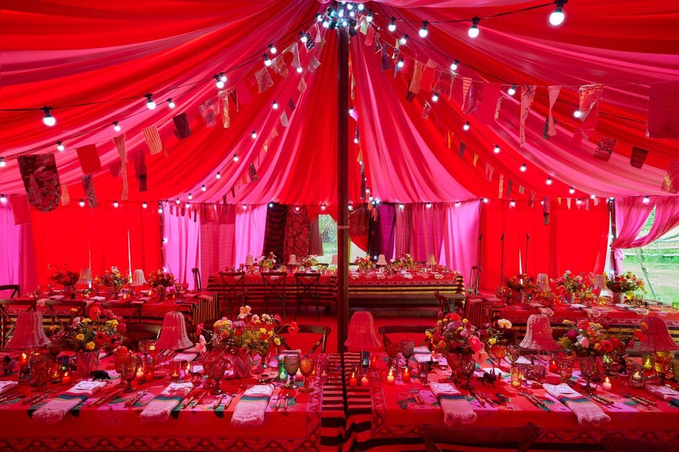 a lavish party setup under a pink tent a lavish party setup under a pink tent