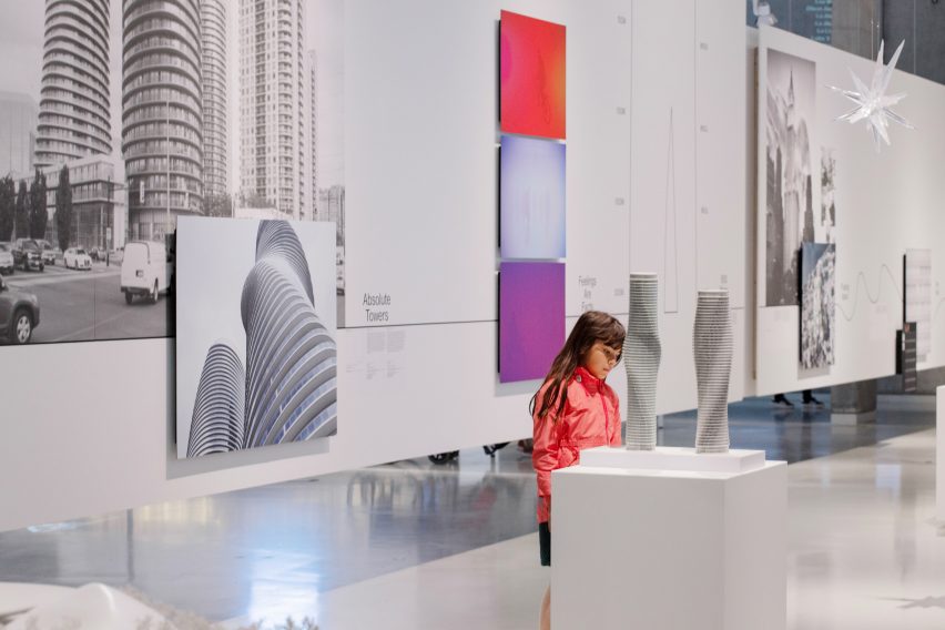 Little girl in red jacket viewing the Absolute Towers model
