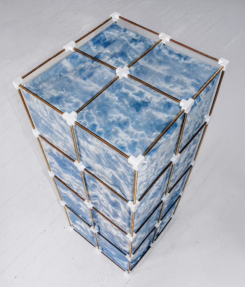 modular brass grid chair draped in velvet replicates coreless exoskeleton skyscrapers