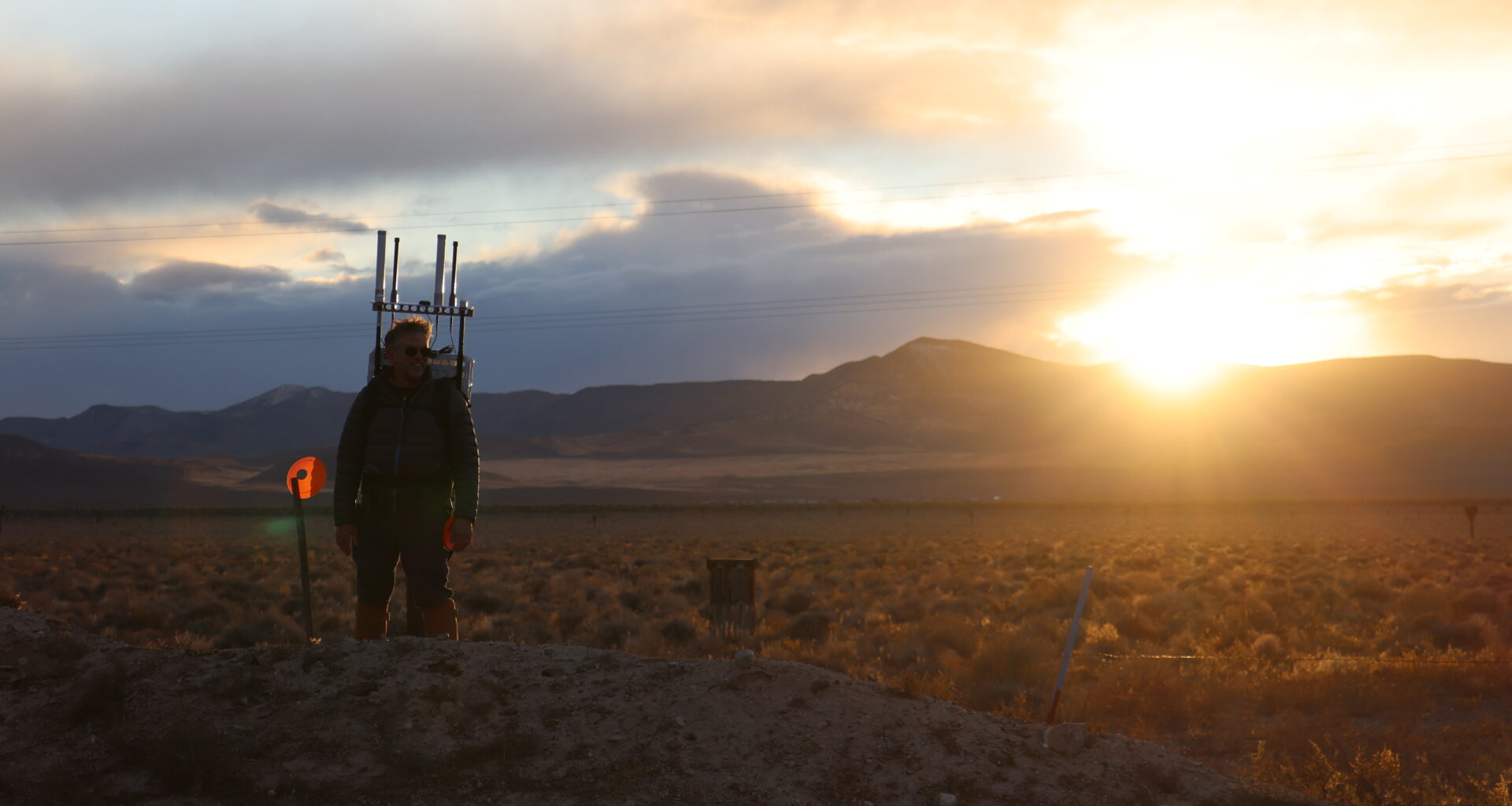 A person walks with a prototype backpack in the Nevada desert.