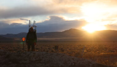 A person walks with a prototype backpack in the Nevada desert.