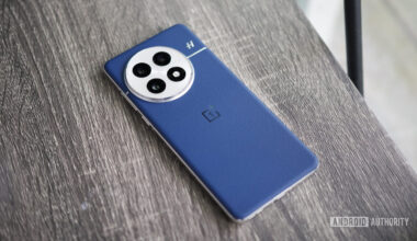 The blue leather OnePlus 13 lying on a shelf.