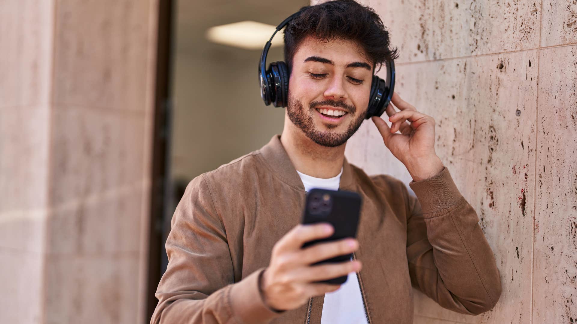 emotionally intelligent man listening to music on his phone