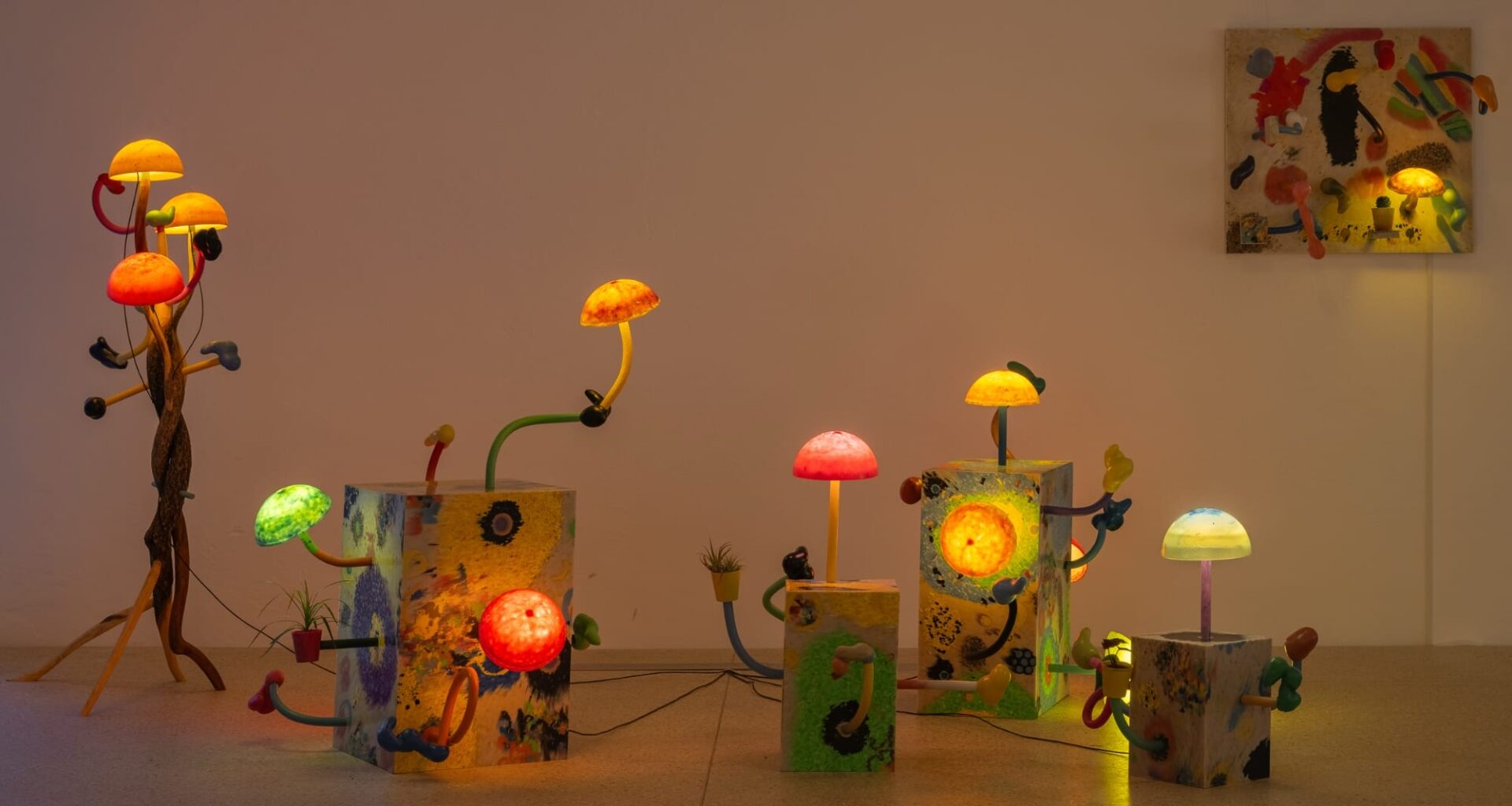 an installation of illuminated mushroom sculptures by Mika Rottenberg in a large white gallery space
