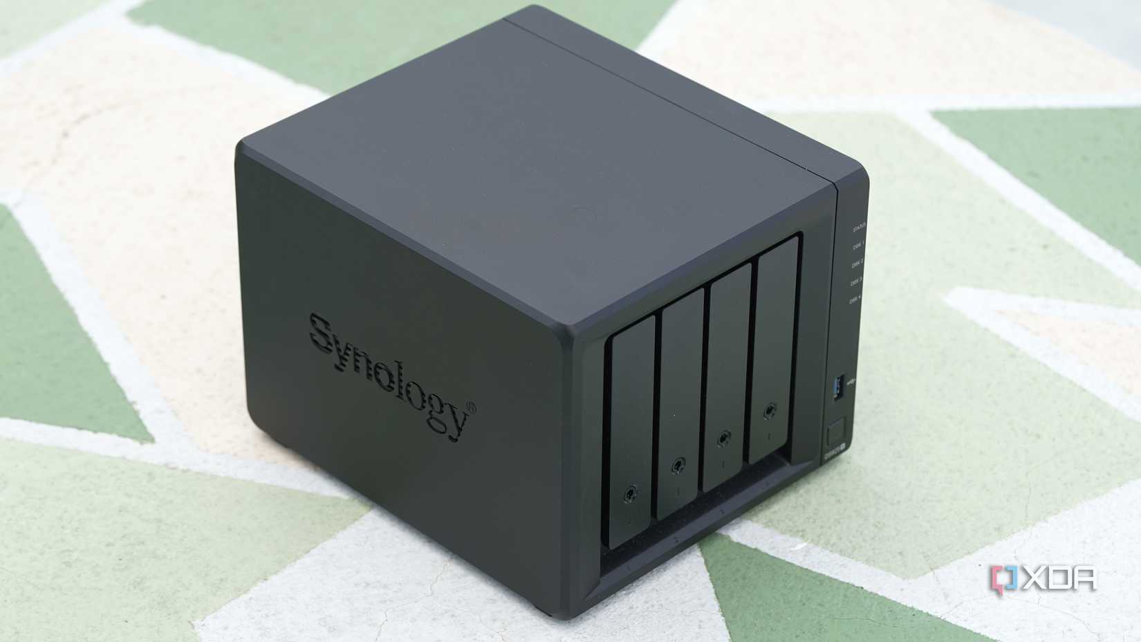 A trimetric perspective shot of a NAS on a green wall with abstract beige and white patches