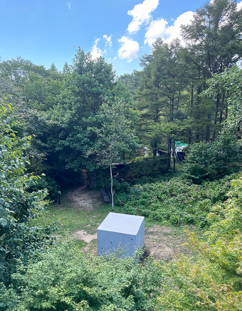 twin concrete cube sculptures link rokko and berlin through tiny video transmission holes
