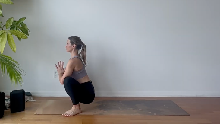 Yoga teacher Julia Eskins practicing yoga for mobility in Garland Pose
