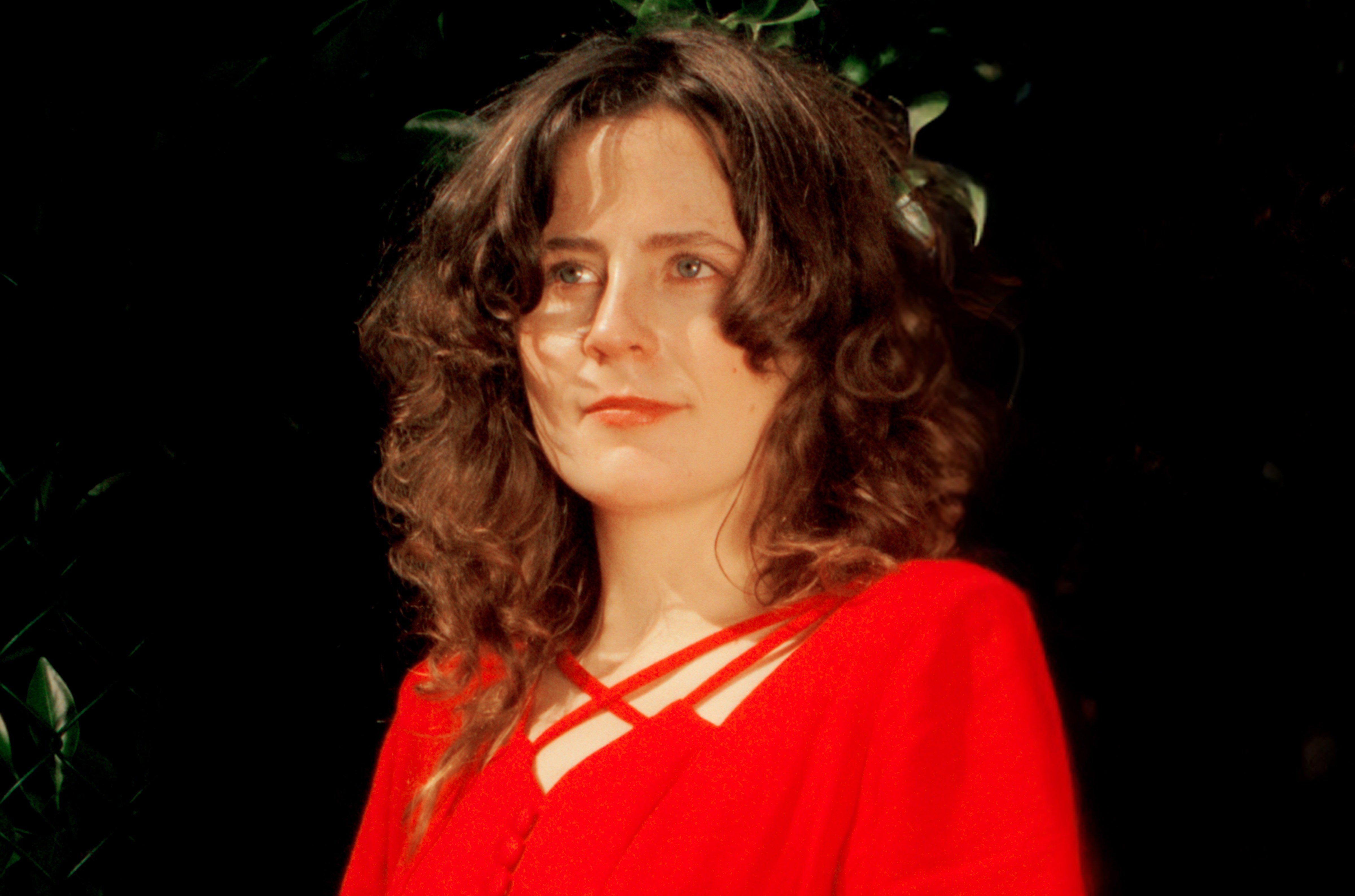 Mary Florence Brown with dark curly hair wearing a red top.