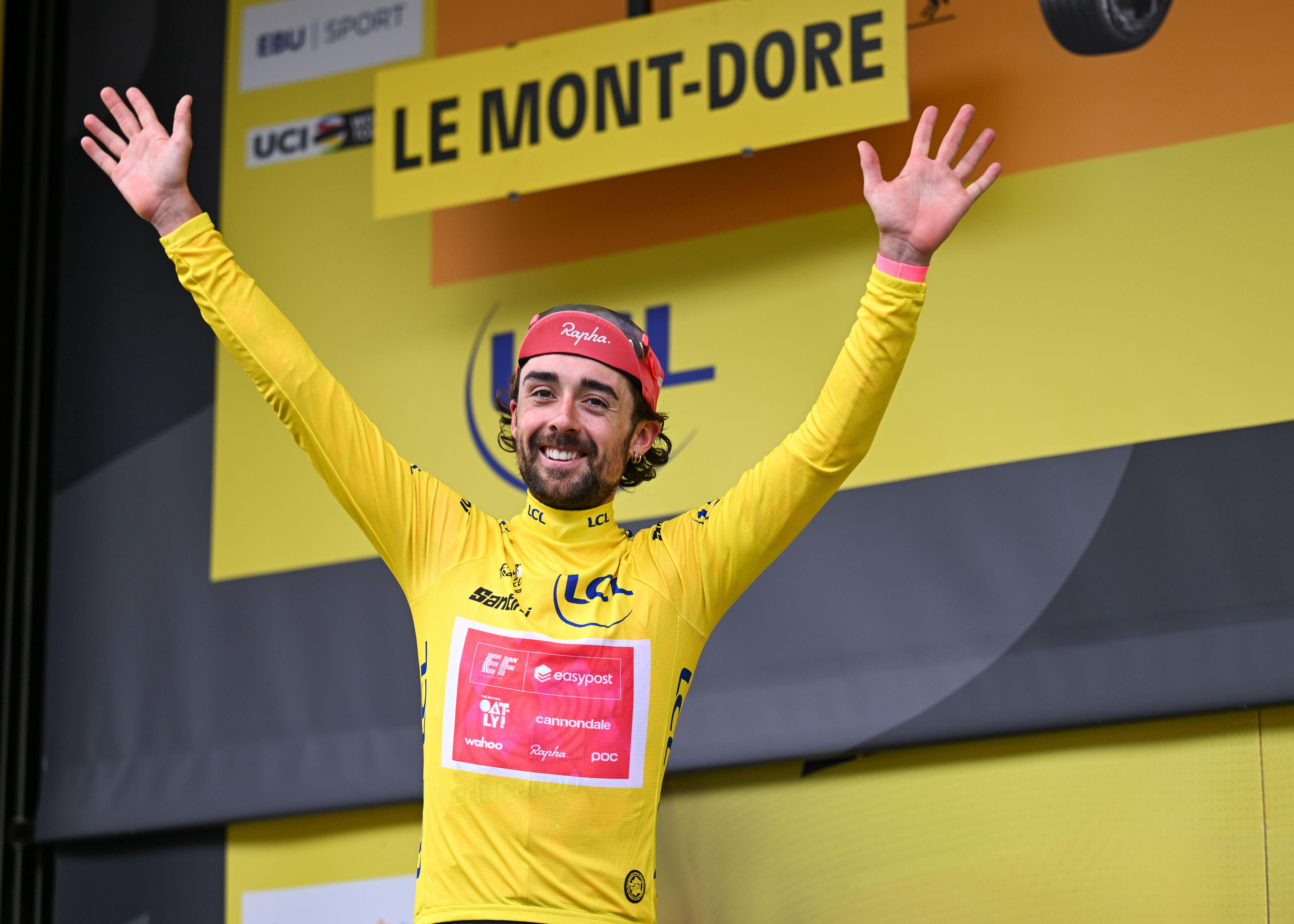 Ben Heal of EF Education-EasyPost on the podium celebrating the yellow jersey.