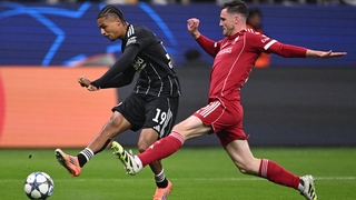 Frankfurt's French forward #19 Jean-Matteo Bahoya (L) gets past Liverpool's Scottish defender #26 Andrew Robertson to shoot during the UEFA Champions League football match between Eintracht Frankfurt and Liverpool FC in Frankfurt, western Germany on Octob