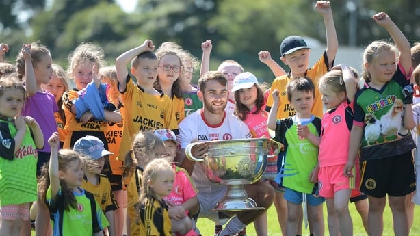 18 July 2017; In attendance during the 2017 GAA Football All Ireland Senior Championship Series National Launch at Loughmacrory St. Teresa's GAA Club, Loughmacrory, Co Tyrone, is Ronan McNamee of Tyrone with club players from the host club and the Sam Maguire Cup. Photo by Cody Glenn/Sportsfile