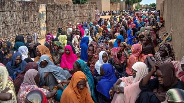 Sudanese residents gather to receive free meals in Al Fasher, a city besieged by Sudan's paramilitary Rapid Support Forces
