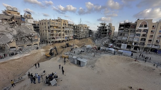 Excavation crews work amid rubble in Hamad City in Gaza