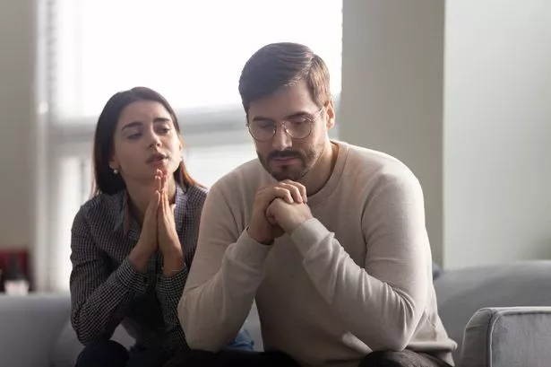 Man and woman looking despondent