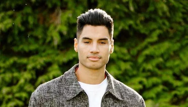 Close up of Siva Kaneswaren looking serious