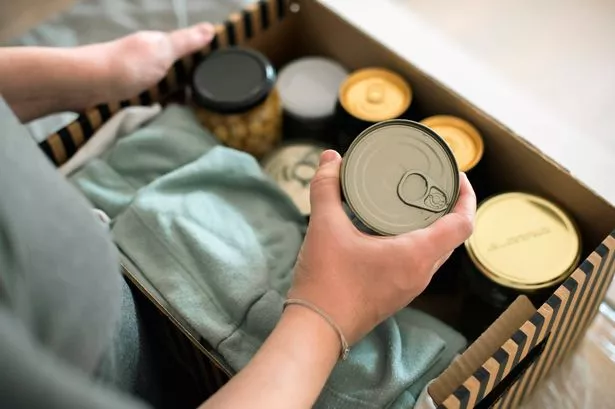 Woman packing tinned foods