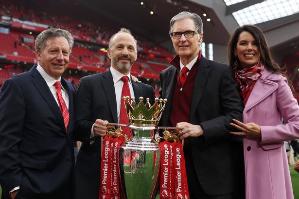 Tom Werner, Chairman of Liverpool, Michael Gordon, President of Fenway Sports Group and John Henry, Principle Owner of Liverpool and his wife Linda Pizzuti Henry pose for a photograph with the Premier League trophy
