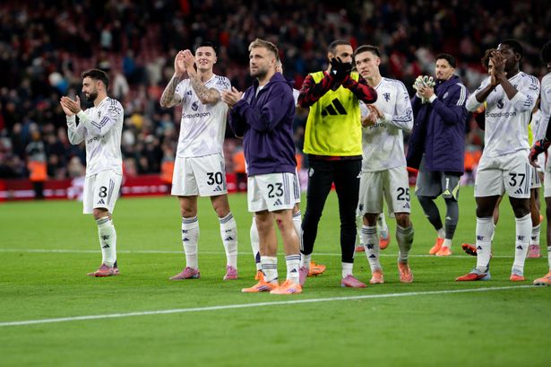 Manchester United fans applaud the travelling support after the win over Liverpool