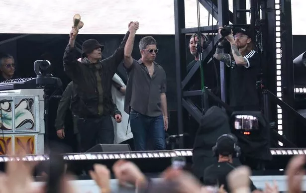 Liam and Noel Gallagher are snapped on stage at Wembley during one of their gigs there last month