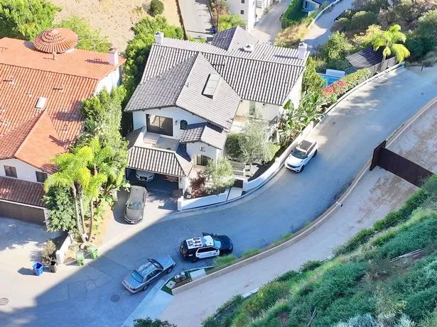 Police have been pictured near Bono's Hollywood Hills investment property