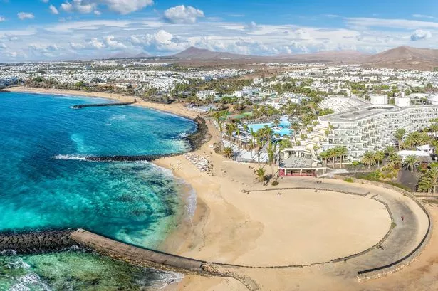 Playa de las Cucharas, Costa Teguise, Lanzarote: A perfect family beach with golden sand, turquoise waters, and a variety of water sports.