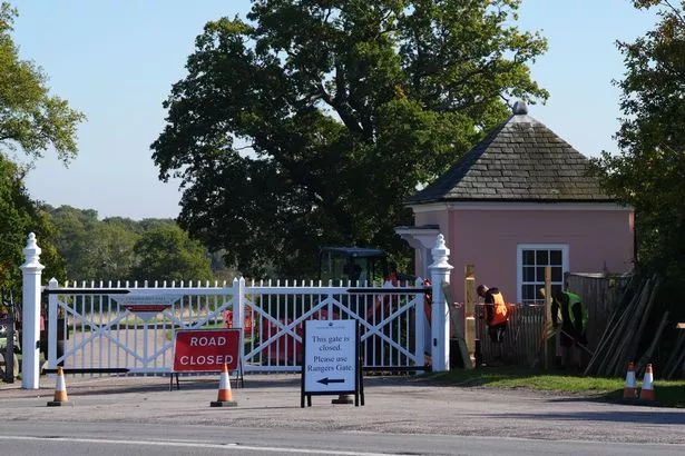 Workmen erecting fences and additional signage after the closure of Cranbourne Gate near Forest Lodge 