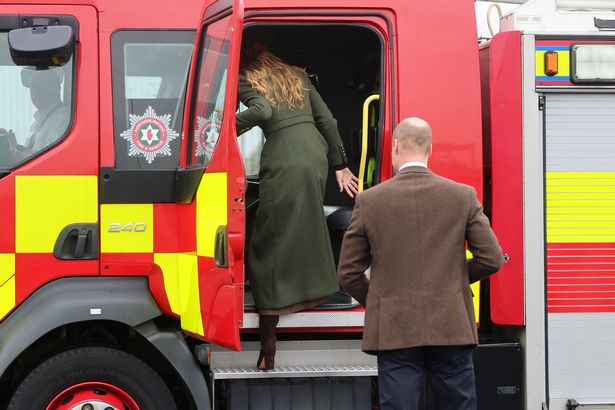 The prince and princess climb into the fire engine 