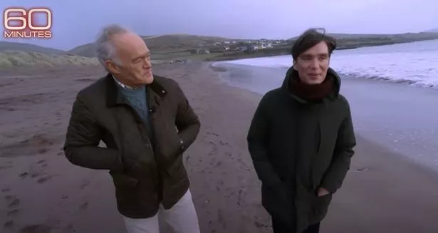 Cillian strolling along the beach during his profile interview on 60 Minutes 