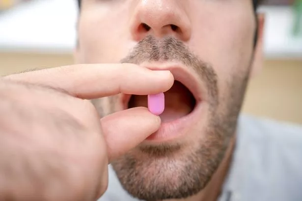 Man Taking Medication