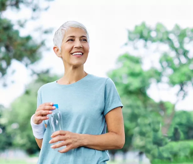 A woman holding a water bottle 
