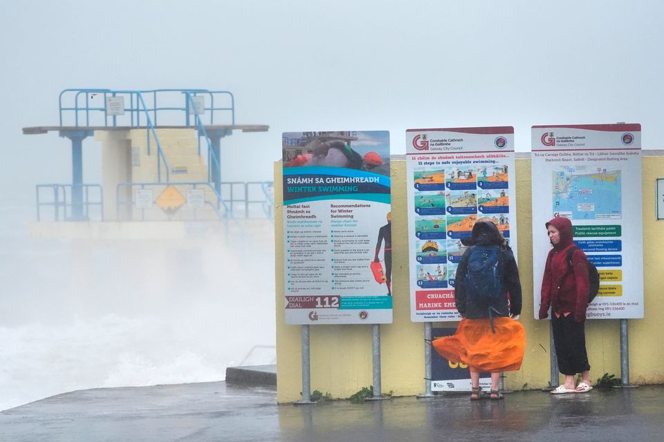People by Blackrock diving tower in Salthill, Galway. Storm Amy will bring damaging winds to the island of Ireland with every county under weather warnings on Friday. Wind speeds could reach up to 80mph (130km/h) along the most exposed coastal areas of the island, with fallen trees and power outages among the potential impacts. Picture date: Friday October 3, 2025. PA Photo. Photo credit should read: Brian Lawless/PA Wire