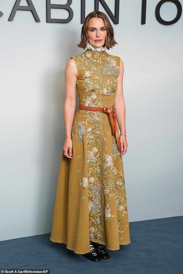 The actress, 40, dazzled in a vintage-inspired olive green gown, covered in embroidered flowers, intricate beading and sparkling diamond details (pictured at the premiere)