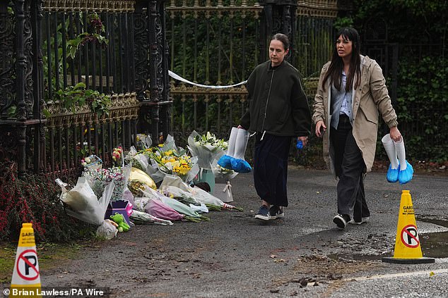 Officers were told the location where his body had been buried. But given the length of time that had lapsed and the circumstances, they were unable to pinpoint exactly where the shallow grave was. Pictured: State pathologists Dr Heidi Okkers (right) and Dr Yvonne McCartney leave the scene, where tributes were laid