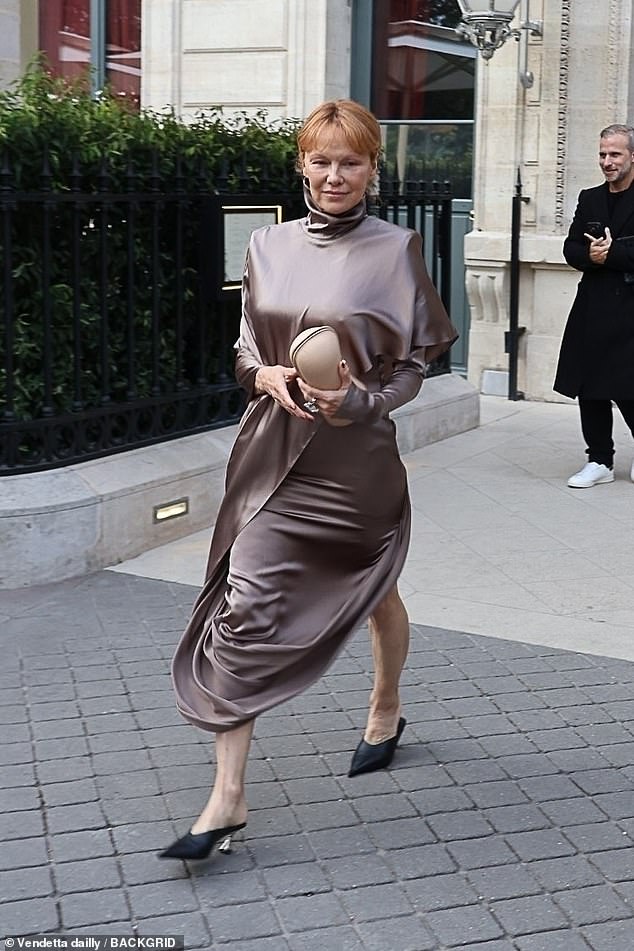 Pamela looked effortlessly classy in a satin gown with a high neckline and long sleeves for the show, sporting her new red hair